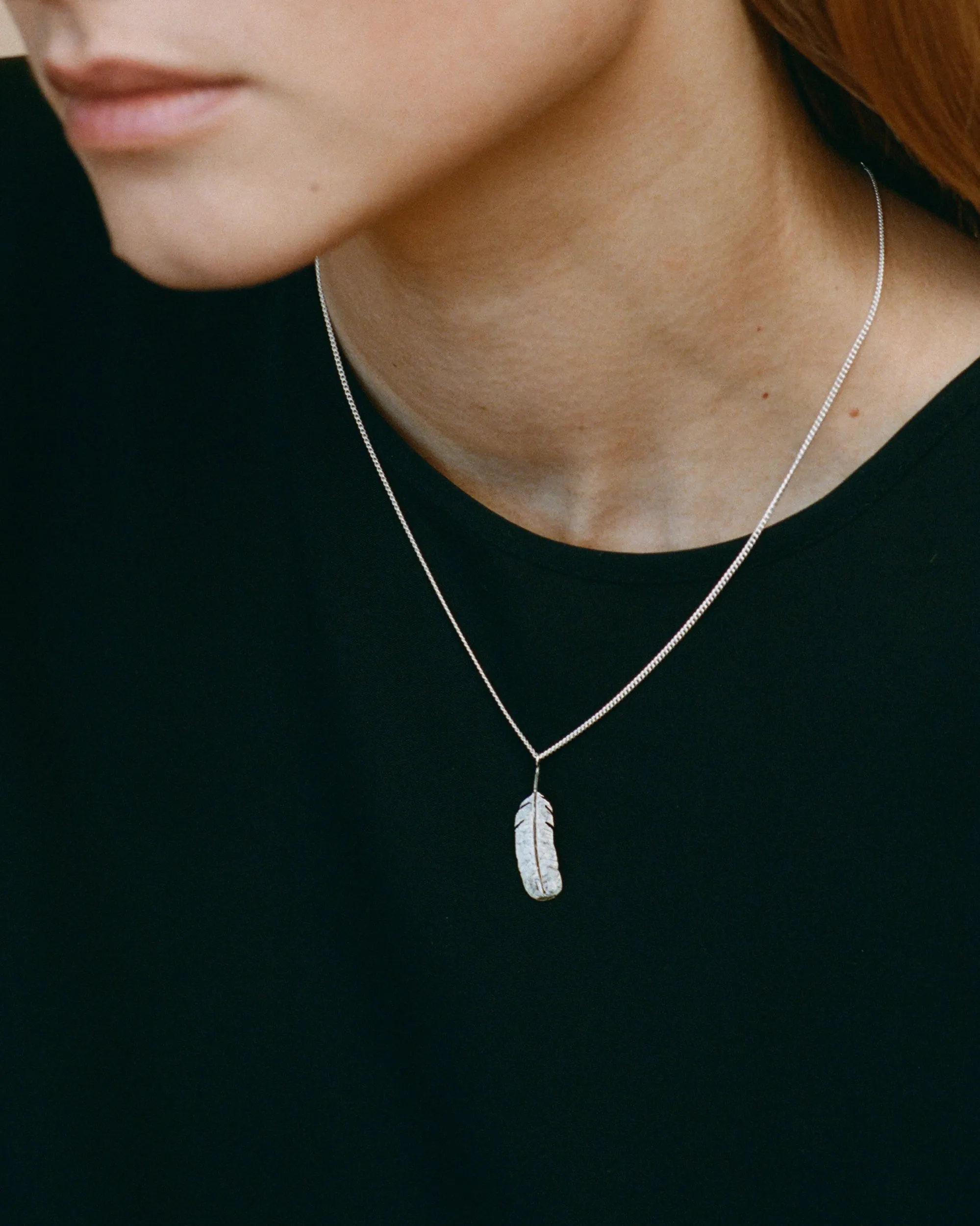 Necklace with feather pendant
